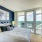 a bed with pillows and a window