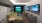 a room with a tv couch and golf simulator