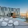 a modern rooftop patio with seating and tv