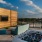 a rooftop patio with a tv on a wall