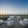a large rooftop patio with seating at sunset