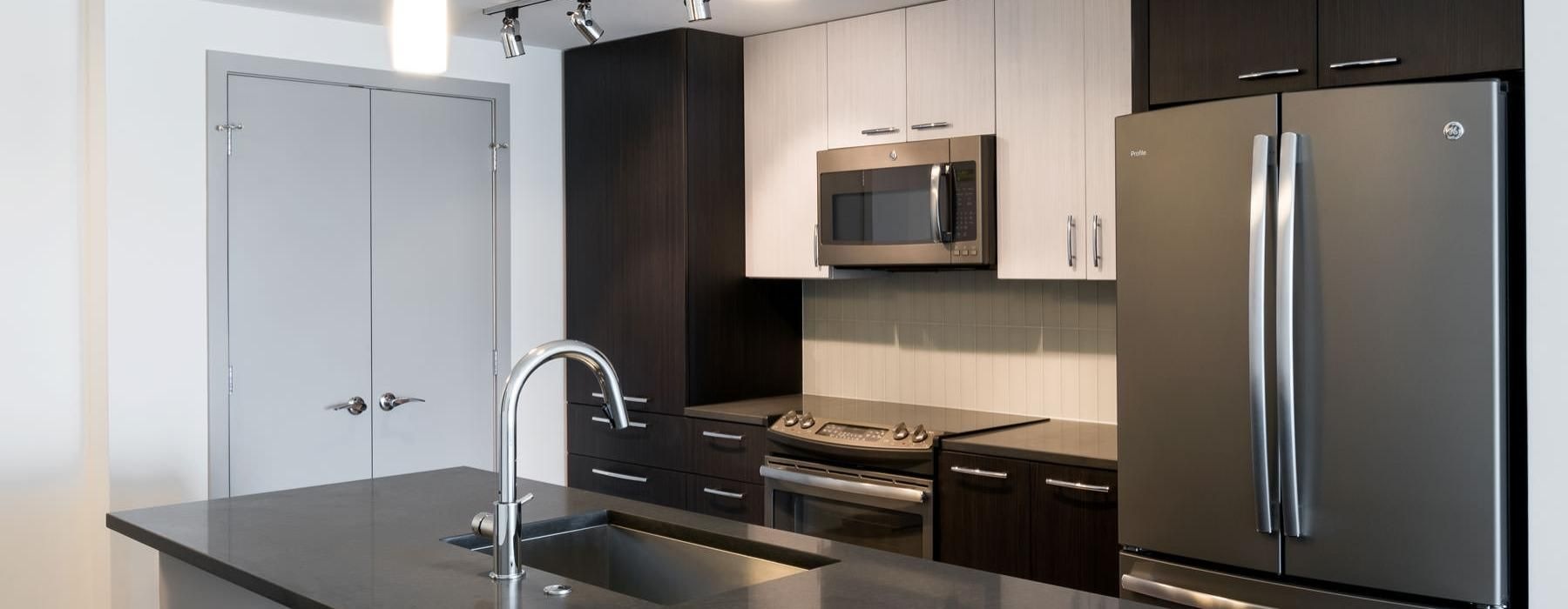 a kitchen with a stainless steel refrigerator